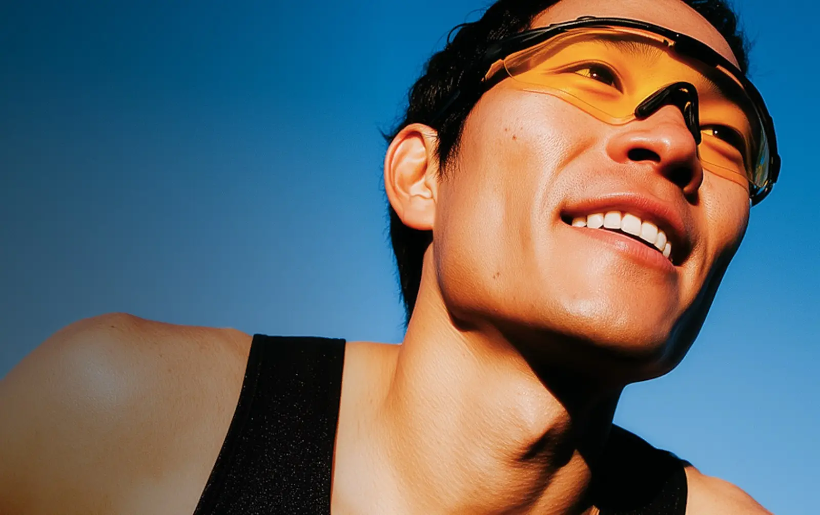 Smiling runner wearing sports sunglasses