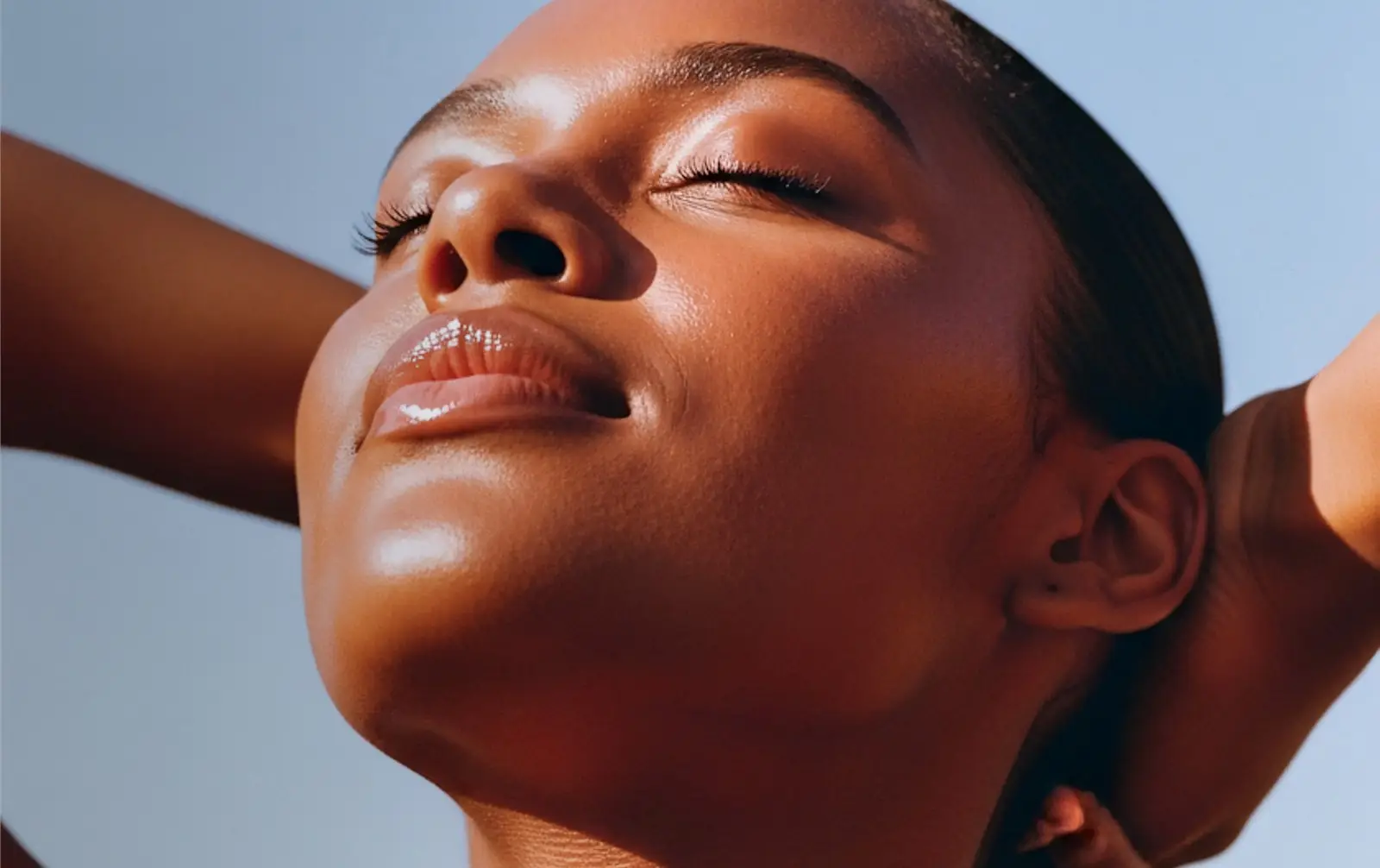 Woman with her face turned toward the sun